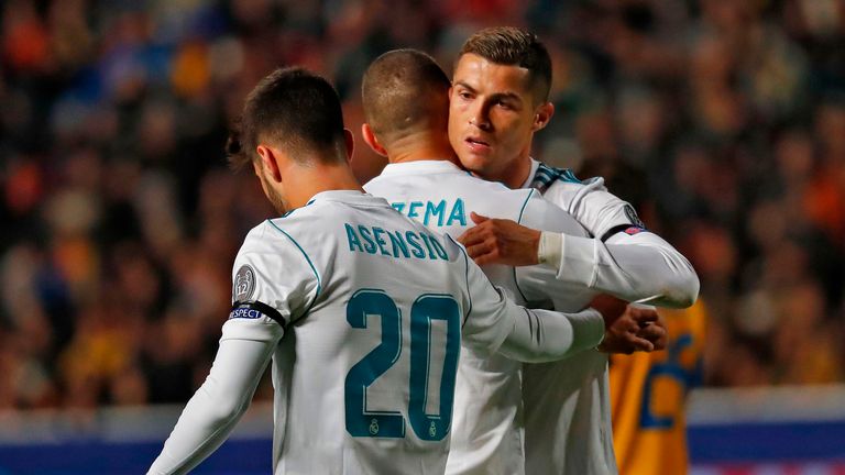 Real Madrid's French forward Karim Benzema (L) hugs teammate Real Madrid's Portuguese forward Cristiano Ronaldo after scoring a goal