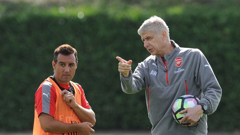 Arsene Wenger with Santi Cazorla at London Colney on September 9, 2016 in St Albans, England.