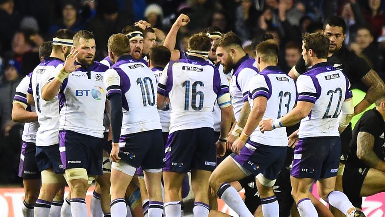 Scotland's centre Huw Jones celebrates with tammates scoring their frst try during the international rugby union test match between Scotland and New Zealan