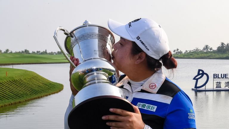 China's Feng Shanshan kisses the trophy after winning the Blue Bay LPGA golf tournament at Jian Lake Blue Bay Golf Course on China's southern Hainan island