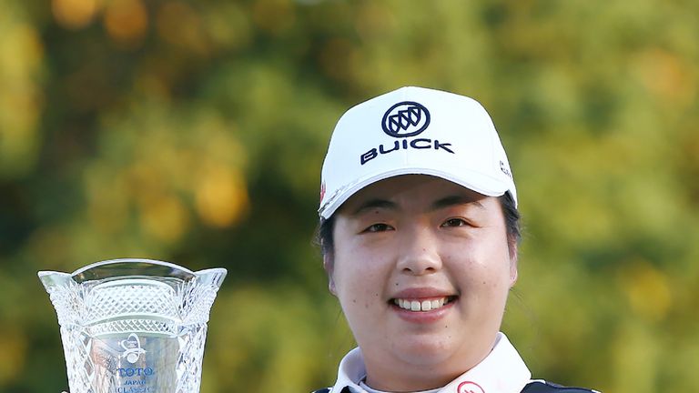 Feng Shanshan of China poses with the trophy after winning the LPGA Japan Classic golf tournament in Omitama, Ibaraki prefecture, on November 5, 2017.
Chin