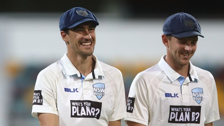 BRISBANE, AUSTRALIA - OCTOBER 26:  Mitchell Starc and Josh Hazlewood of the Blues talk during day two of the Sheffield Shield match between Queensland Bull