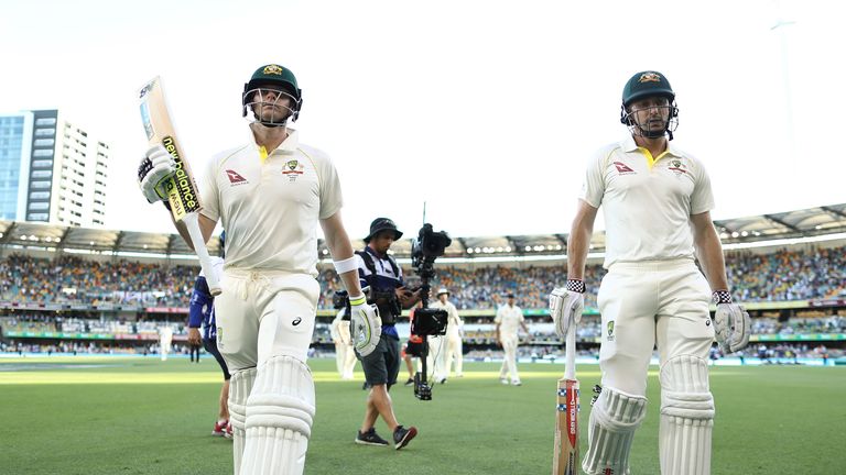 BRISBANE, AUSTRALIA - NOVEMBER 24:  Steve Smith and Shaun Marsh of Australia walk fro the ground at stumps during day two of the First Test Match of the 20