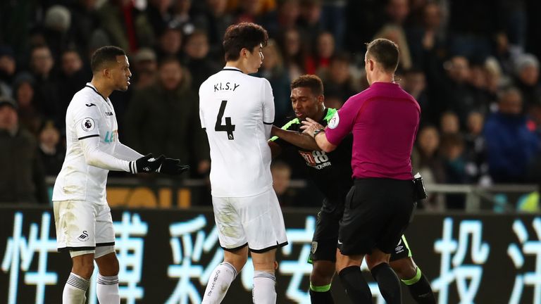 SWANSEA, WALES - NOVEMBER 25:  Alfie Mawson and Ki Sung-Yueng of Swansea City clash with Jordon Ibe of AFC Bournemouth during the Premier League match betw