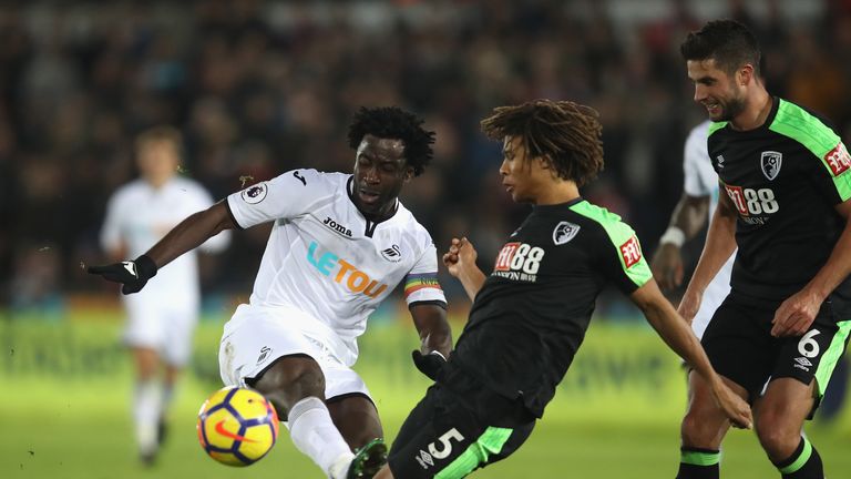 SWANSEA, WALES - NOVEMBER 25: Nathan Ake of AFC Bournemouth blocks Wilfried Bony of Swansea City shot during the Premier League match between Swansea City 