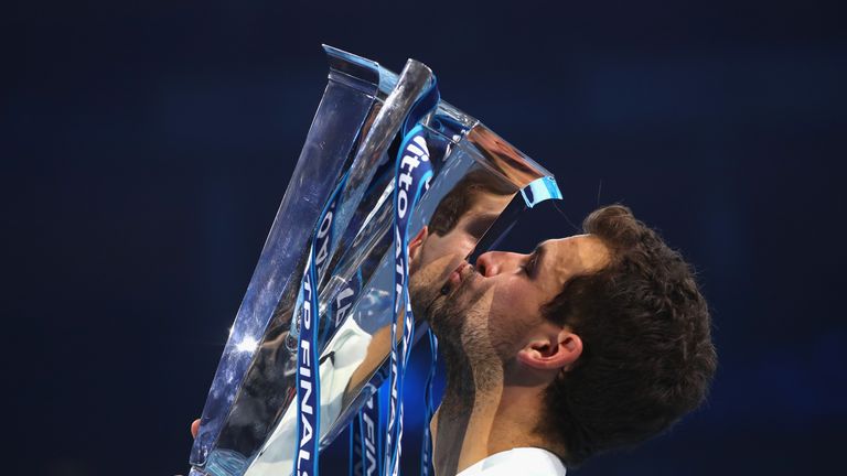 Grigor Dimitrov of Bulgaria kisses the trophy as he celebrates victory following the singles final against David Goffin