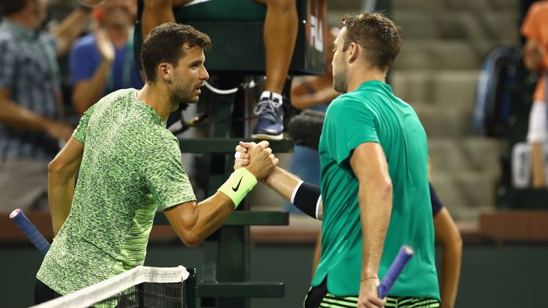 Jack Sock of the United States shakes hands at the net after his three set victory against Grigor Dimitrov of Bulgaria