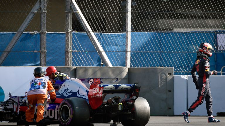 Toro Rosso's French driver Pierre Gasly (R) leaves his car during first qualifying session of the F1 Mexico Grand Prix at the Hermanos Rodriguez circuit in