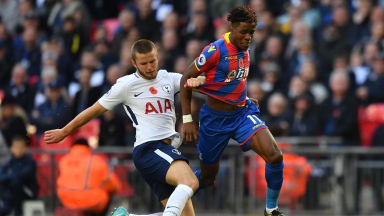 Tottenham Hotspur's Danish midfielder Christian Eriksen (L) clears the ball from the feet of Crystal Palace's Ivorian striker Wilfried Zaha during the Engl