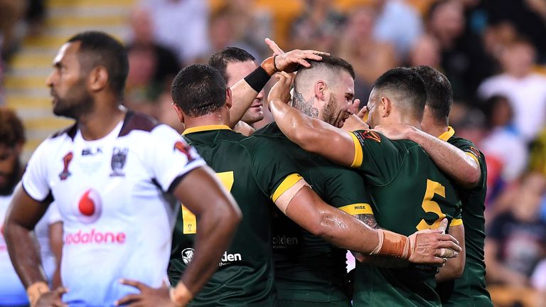 Valentine Holmes is congratulated by team-mates after scoring in Australia's semi-final win over Fiji