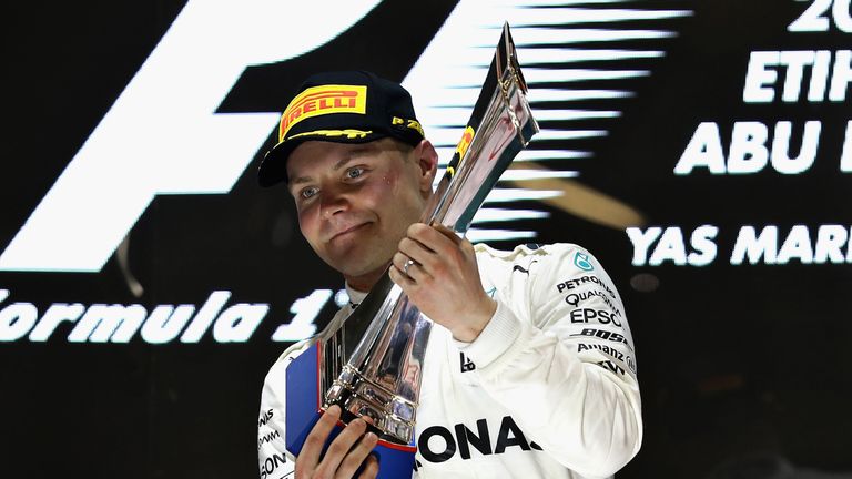 ABU DHABI, UNITED ARAB EMIRATES - NOVEMBER 26:  Race winner Valtteri Bottas of Finland and Mercedes GP celebrates on the podium during the Abu Dhabi Formul
