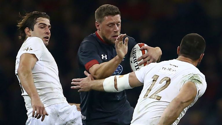 Wales' fly-half Rhys Priestland  is tackled by Georgia's centre Merab Sharikadze  