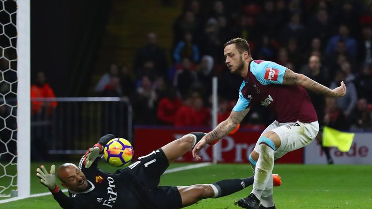 Heurelho Gomes of Watford makes a save from Marko Arnautovic of West Ham United (R) 