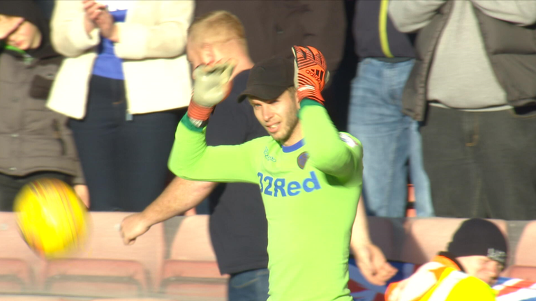 Felix Wiedwald receives a hat from a Leeds fan against Barnsley