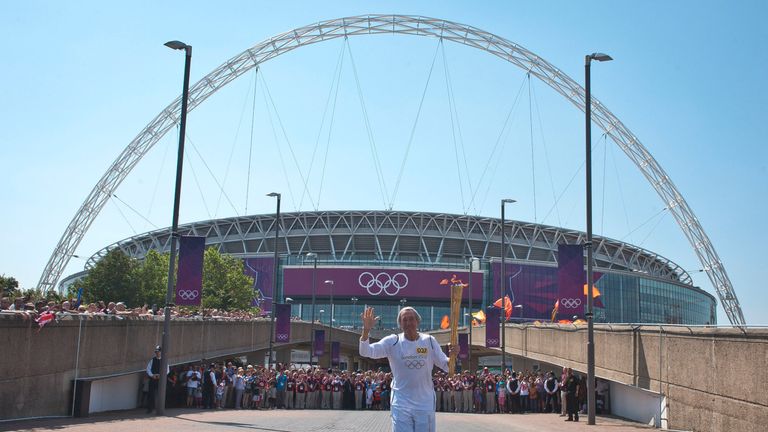 Gordon Banks carries the Olympic flame at Wembley in July 2012