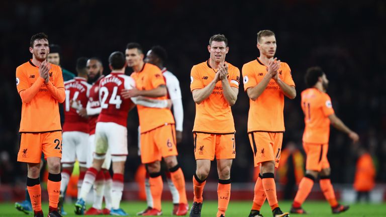 James Milner and Ragnar Klavan of Liverpool applaud the travelling fans after the Premier League match against Arsenal.