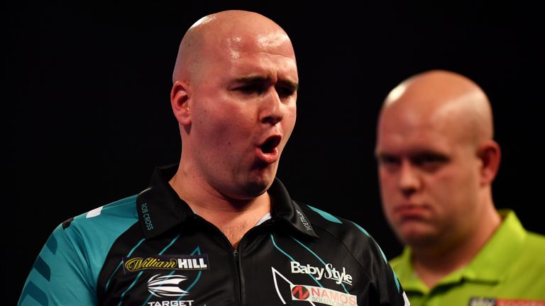 Rob Cross celebrates during his Semi-Final Match as Michael van Gerwen looks on during the 2018 William Hill PDC World Darts Championship