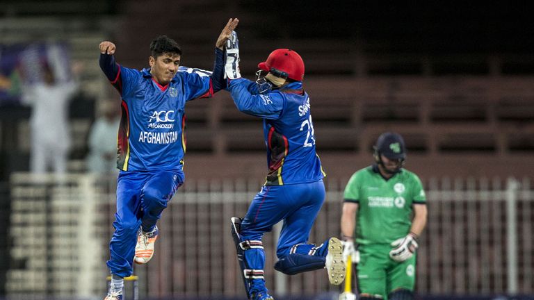 Afghanistan's Mujeeb Zadran (L) celebrates the wicket of Ireland's William Porterfield during the third one day international (ODI) cricket match between A