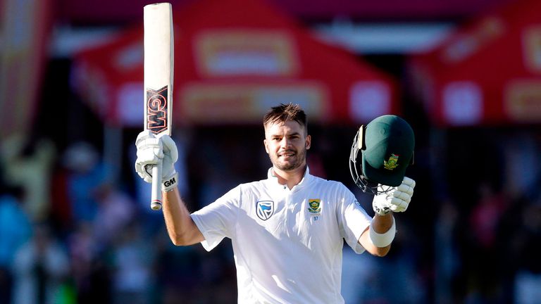 South African's Aiden Markram raises his bat and helmet as he celebrates after scoring a century during the first day of the day-night Test