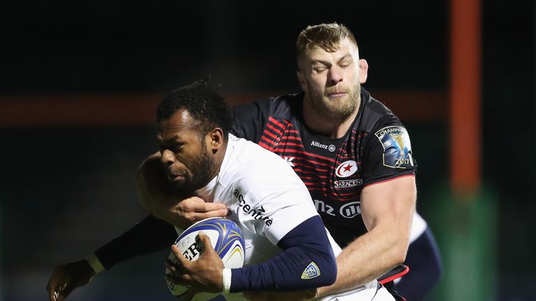 BARNET, ENGLAND - DECEMBER 11:  Alivereti Raka of Clermont Auvergne is tackled by George Kruis of Saracens during the European Rugby Champions Cup match be