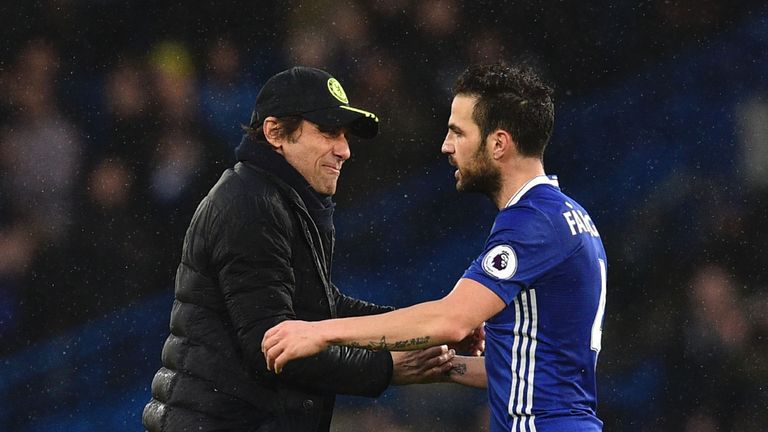Chelsea's Italian head coach Antonio Conte (L) shakes hands with Chelsea's Spanish midfielder Cesc Fabregas (R) on the pitch at the end of the English Prem