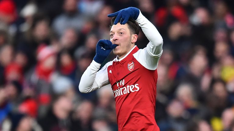 Mesut Ozil celebrates scoring against Newcastle