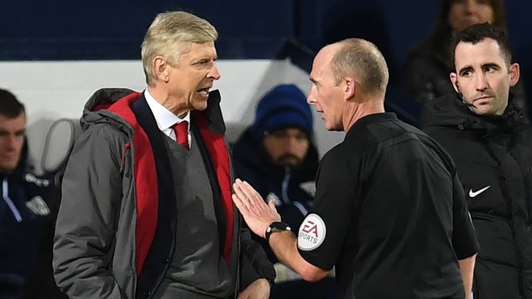 Arsenal's French manager Arsene Wenger (L) has words with English referee Mike Dean during the English Premier League football match between West Bromwich 