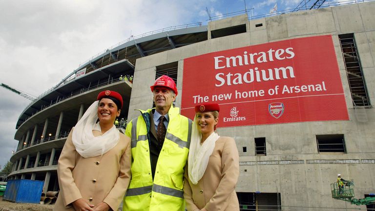 Arsene Wenger poses in front of Arsenal's new home - the Emirates Stadium 