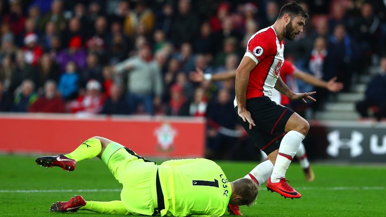 Charlie Austin challenges Jonas Lossl in Southampton's 1-1 draw with Huddersfield.