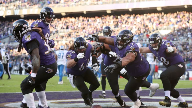 BALTIMORE, MD - DECEMBER 3: Running Back Alex Collins #34 of the Baltimore Ravens celebrates with teammates after a touchdown in the fourth quarter against
