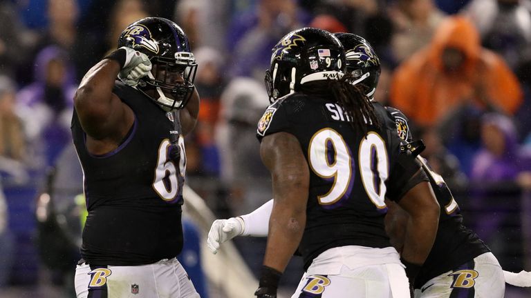 BALTIMORE, MD - DECEMBER 23: Defensive Tackle Willie Henry #69 and defensive end Za'Darius Smith #90 of the Baltimore Ravens celebrate after a sack in the 