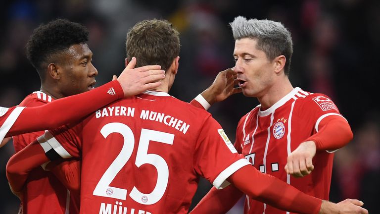(LtoR) Bayern Munich's  Austrian defender David Alaba, striker Thomas Mueller and Polish striker Robert Lewandowski celebrate after the first goal during t