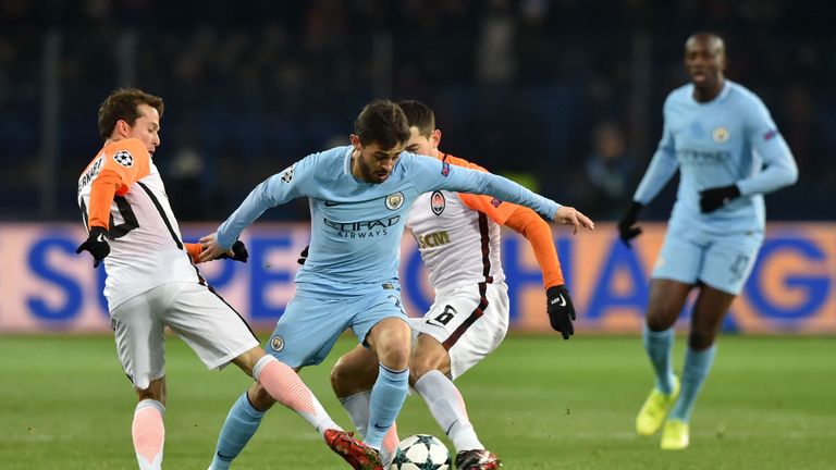 Manchester City's Portuguese midfielder Bernardo Silva (2nd-L) drives the ball next to Shakhtar Donetsk's Brazilian midfielder Bernard (1st-L) and Shakhtar