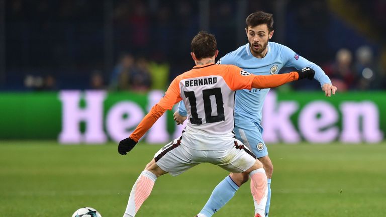 Manchester City's Portuguese midfielder Bernardo Silva (R) passes the ball during the UEFA Champions League group F football match between Shakhtar Donetsk