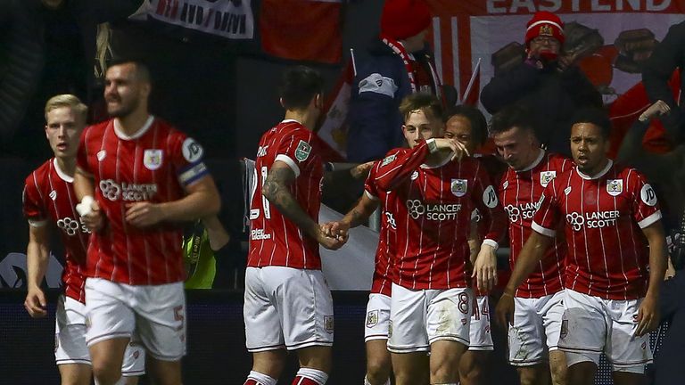 Bristol City's defender Joe Bryan celebrates with teammates, scoring the team's first goal during the English League Cup quarter-final football match