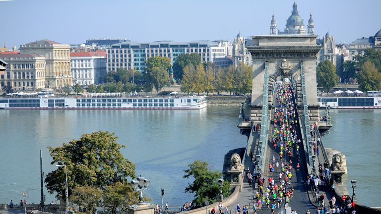 Runners run between Buda and Pest city parts on the Lanchid bridge, over the Danube, during the 29th Spar Budapest marathon, on October 11, 2014 in the Hun