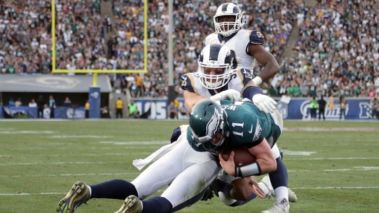 LOS ANGELES, CA - DECEMBER 10:  Carson Wentz #11 of the Philadelphia Eagles is hit by Mark Barron #26 of the Los Angeles Rams during the third quarter of t