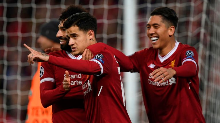 Liverpool's Brazilian midfielder Philippe Coutinho (C) celebrates scoring their fifth goal and completing his hattrick with Liverpool's Egyptian midfielder
