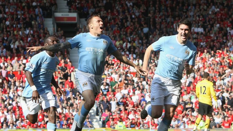 Craig Bellamy celebrates scoring their second goal during the Premier League match between Manchester United and Manchester City at Old Trafford