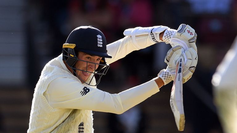 England batsman Craig Overton (L) steers a ball past Australian fieldsman Cameron Bancroft (R) on the third day of the second Ashes cricket Test match in A