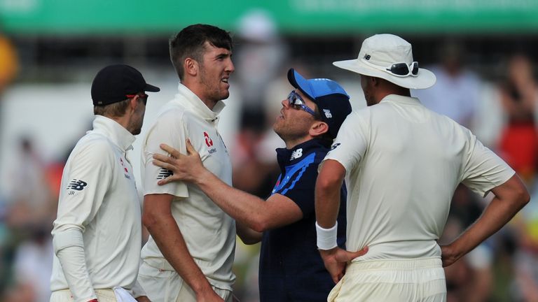 England's Craig Overton (2nd-L) is checked over after appearing to injury himself while bowling on day two of the third Ashes cricket Test match in Perth o