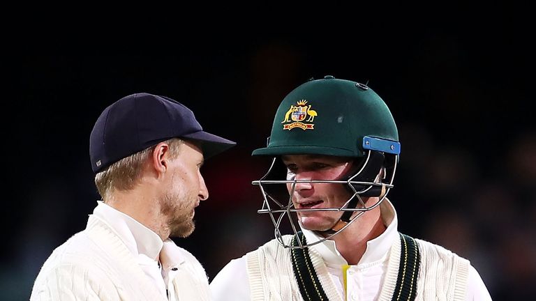 Joe Root of England and Peter Handscomb exchange words as they the field at the end of play day three of the Second Ashes Test in Adelaide, Australia