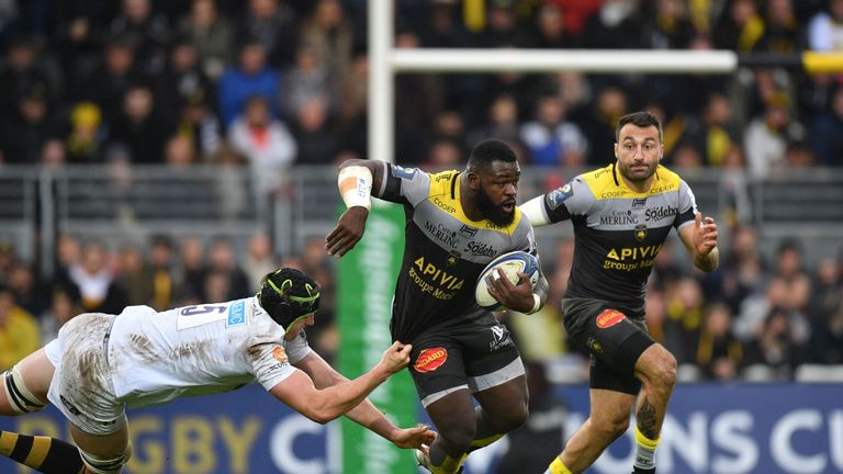 La Rochelle's French prop Dany Priso (C) is tackled by Wasp's lock James Gaskell during the European Rugby Champions Cup match 10,12,2017