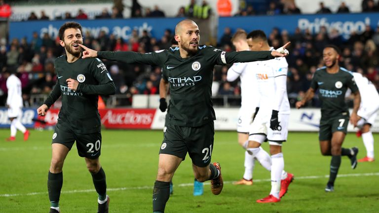 Manchester City's David Silva (centre) celebrates his side's third goal of the game during the Premier League match at the Liberty Stadium, Swansea