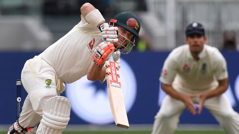 Australian batsman David Warner (L) drives a ball as England's Alastair Cook (R) looks on, on the fourth day of the fourth Ashes cricket Test match at the 