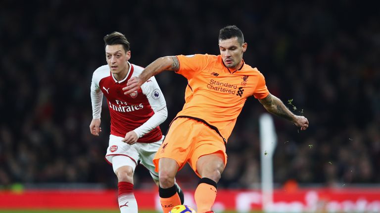 Liverpool defender Dejan Lovren clears the ball from Mesut Ozil of Arsenal 