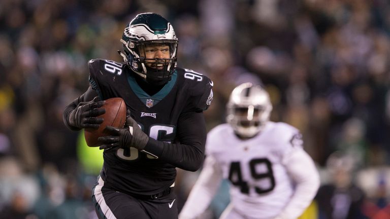 PHILADELPHIA, PA - DECEMBER 25: Derek Barnett #96 of the Philadelphia Eagles picks up a fumble and runs past Jamize Olawale #49 of the Oakland Raiders to s