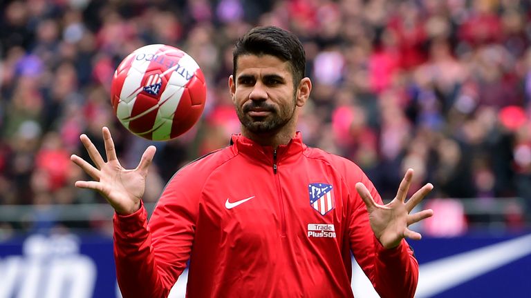 Atletico Madrid's Spanish forward Diego Costa catches a ball at the start of a training session following his welcoming ceremony at the Wanda Metropolitan 