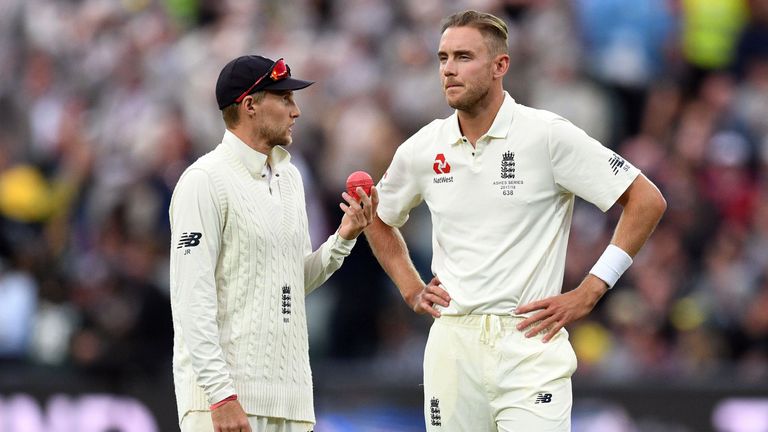 England's captain Joe Root (L) speaks to his fast bowler Stuart Broad on the second day of the second Ashes cricket Test match against Australia in Adelaid