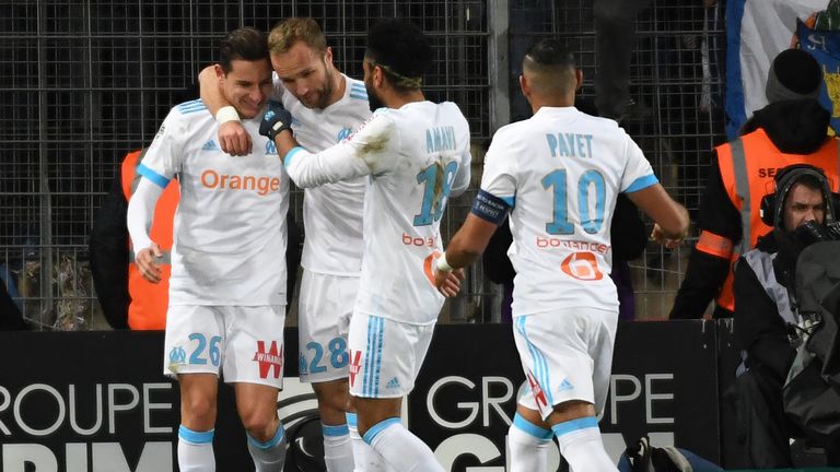 Marseille's French midfielder Florian Thauvin (L) is congratulated by Marseille's French forward Valere Germain, Marseille's French defender Jordan Amavi a